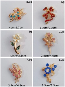 Detail view of colorful rhinestone flower and clover alloy brooches in various designs