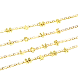 Close-up of gold-plated tennis chains with LOVE and MAMA zircon-encrusted letter pendants