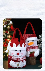 Detail of Christmas gift bags featuring plush snowman and reindeer motifs with knit textures