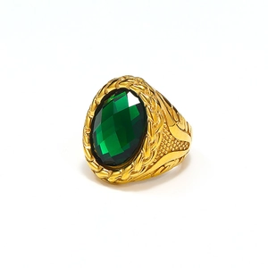 Detail of emerald green oval gemstone on gold braided texture cast stainless steel ring