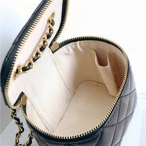 Detail of quilted sheepskin leather bag showing interior lining and gold chain strap