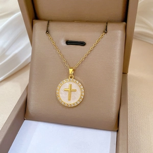 Detail of luxury gold cross necklace with mother of pearl and sparkling crystals