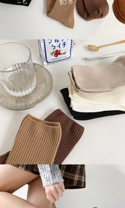 Detailed view of ribbed cotton crew socks in neutral tones like beige and coffee