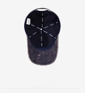 Detail view of the washed denim baseball cap interior with metal buckle and stitching