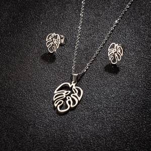 Silver stainless steel jewelry set featuring cutout monstera leaf necklace and earrings