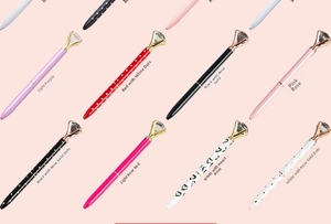 Detailed view of diamond ballpoint pens in various colors with metallic accents and patterns