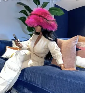 Close-up of fluffy hot pink faux fur hat with thick texture and punk style appeal