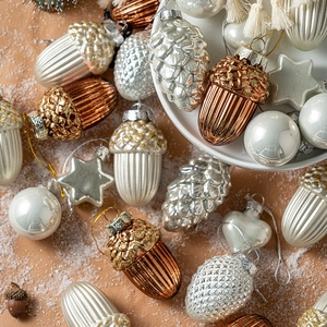 Elegant Christmas tree ornament set featuring metallic acorns and stars in festive layout