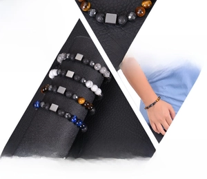 Detailed display of natural gemstone bracelets with tiger eye, lava stone and metal bead