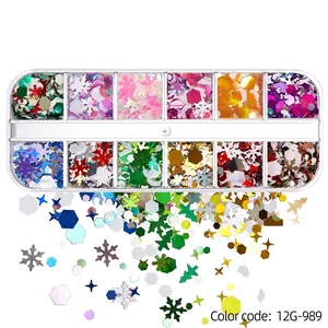 Close-up of 12-grid Christmas glitter set with snowflakes and stars for nail art decor