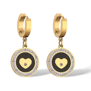 Golden circle earrings with black enamel heart charm and cubic zirconia on white background