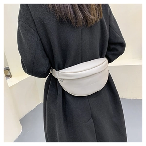 Minimalist creamy white leather fanny pack worn crossbody style by a model back view
