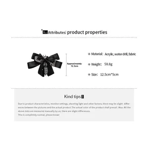 Detail view of black fabric bow hair claw clip with acrylic rhinestones, 12.5cm size