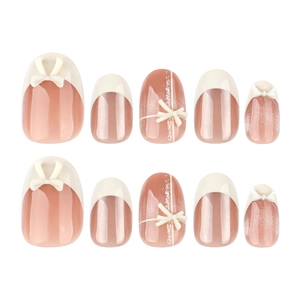 Short oval cat eye press-on nails with 3D bows and silver glitter in nude pink and white