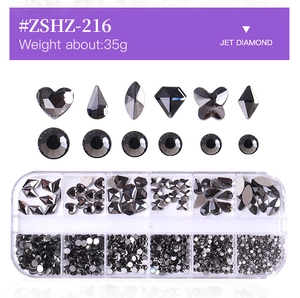 Macro detail of 12-slot box with various black jet diamond rhinestones for nail art designs