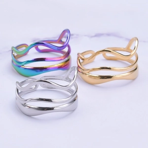 Detailed view of wave-textured adjustable rings in rainbow, gold, and silver finishes