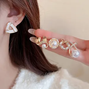 Elegant geometric pearl stud earrings with sparkling diamonds and gold finish for women
