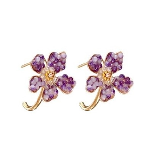 Vintage gold C-shaped flower earrings with purple and clear crystals on white backdrop