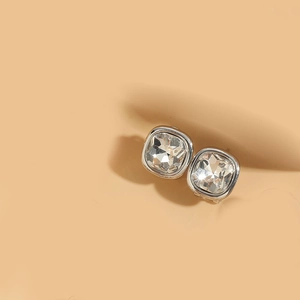 Detailed close-up of square cut crystals in silver bezel setting minimalist stud earrings
