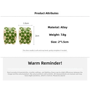 Detailed view of vintage gold flower earrings with green enamel and size parameters