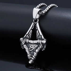 Macro shot of silver Eye of Horus stainless steel triangle pendant on a chain
