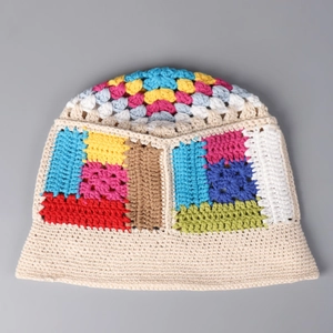 Detailed macro view of colorful crochet patchwork pattern on a cotton knit bucket hat
