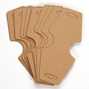 Close-up of blank kraft paper jewelry display cards with pre-cut holes for packaging