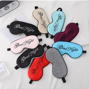 Flat lay of colorful satin eye masks with Good Night embroidery in nine different colors