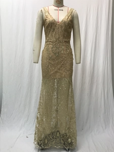 Detail of sequined champagne evening dress with V-neckline and elegant mesh embroidery