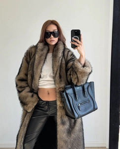 Detail of luxurious faux fox fur texture on long brown and black patterned coat