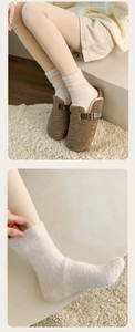 Close-up of cozy white fleece socks with brown plush slippers on a soft home carpet