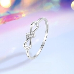 Macro detail of S925 sterling silver bow ring featuring micro-pave zircon gemstones
