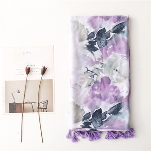 Bohemian purple ink floral shawl scarf with tassels laid flat on a white background