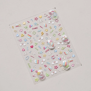 Detailed macro view of 3D embossed nail stickers featuring pastel rainbow and star patterns