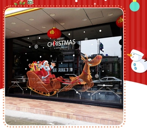 Detail of Santa Claus sleigh and reindeer Christmas window decals on a glass storefront