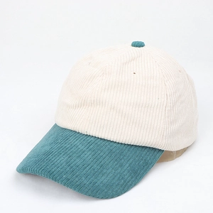 Detailed view of two-tone corduroy baseball cap with cream crown and green brim