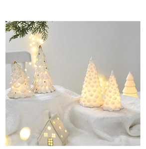 Ceramic mini Christmas tree night light with warm glow and golden dots on snow base