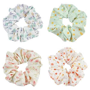 Set of four floral organza scrunchies in white, green, and beige for ponytails