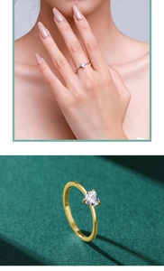 Detailed close-up of gold and silver heart-shaped solitaire rings with claw-set stones