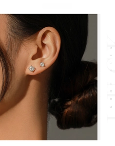Comparison of 5mm and 6.5mm moissanite stud earrings on ear for size reference