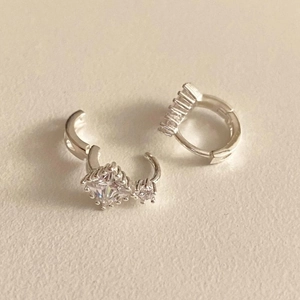 Macro detail of S925 sterling silver huggie earrings with square zircon stone