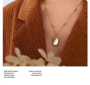 Detail of 18K gold plated titanium steel necklace with a shell rose pendant