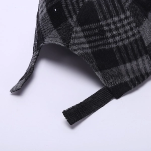 Detail of wool-like plaid baseball cap featuring adjustable velcro strap on the back