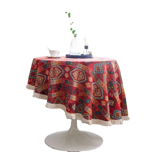 Elegant red round tablecloth with geometric jacquard patterns and cream fringe accents