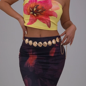 Bohemian gold metal waist chain featuring textured starfish charms on a female model