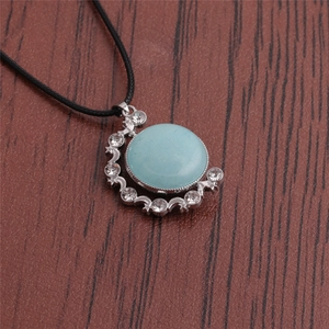 Detailed shot of celestial moon and star pendant with blue turquoise and crystals
