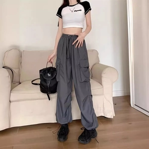 Women's baggy cargo pants with drawstring waist and multiple pockets in dark grey