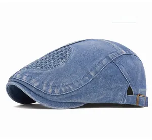 Detail of blue denim ivy cap featuring woven mesh texture and adjustable bronze buckle