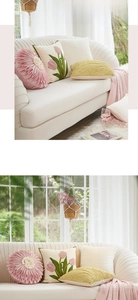 Detail of Nordic pink tulip embroidered cushions and pleated pillows on white sofa