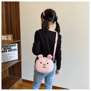 Close-up of pink fuzzy bear shoulder bag with cute ears and adjustable strap
